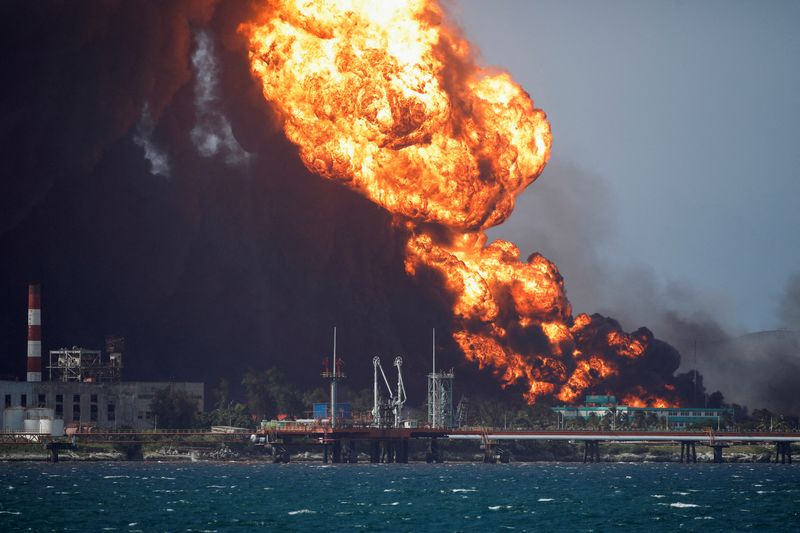 &copy; Reuters. FILE PHOTO: Fire is seen over fuel storage tanks that exploded near Cuba's supertanker port in Matanzas, Cuba, August 8, 2022. REUTERS/Alexandre Meneghini