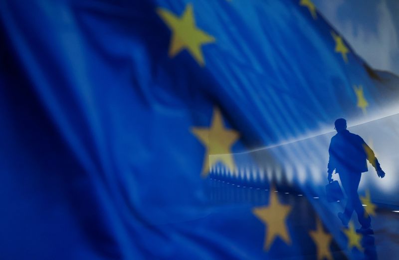 &copy; Reuters. FILE PHOTO: A man is seen in a reflection with a EU flag in the background as he walks in a corridor of the Bundestag in Berlin, Germany February 16, 2022. REUTERS/Michele Tantussi