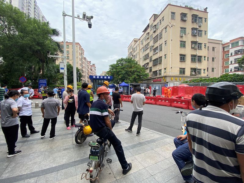 &copy; Reuters. Varias personas observan la instalación de barricadas a la entrada de un área residencial, como parte de las medidas frente al COVID-19 en Shenzhen, provincia de Guangdong, China, el 29 de agosto de 2022. REUTERS/David Kirton