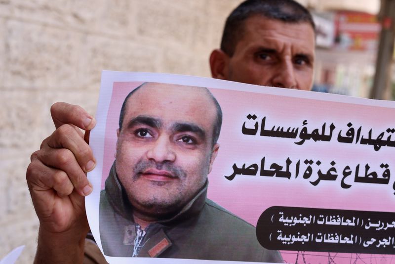 &copy; Reuters. A man holds a picture of Mohammad El Halabi, during a solidarity gathering following an Israeli court decision to sentence him for 12 years, outside the office of the International Committee of the Red Cross in Gaza City August 30, 2022. REUTERS/Mohammed 