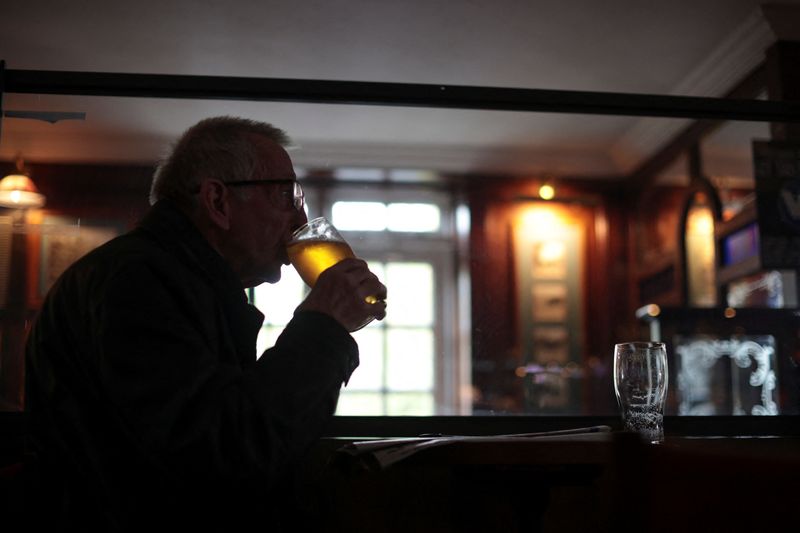 &copy; Reuters. A man drinks beer at The Fox on the Hill pub as it reopens while coronavirus disease (COVID-19) restrictions continue to ease, in London, Britain, May 17, 2021. REUTERS/Hannah McKay