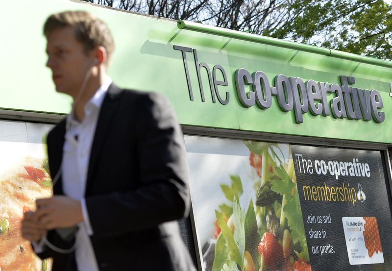 &copy; Reuters. FILE PHOTO: A pedestrian passes a Co-operative retail store in east London, April 10, 2014. REUTERS/Toby Melville 