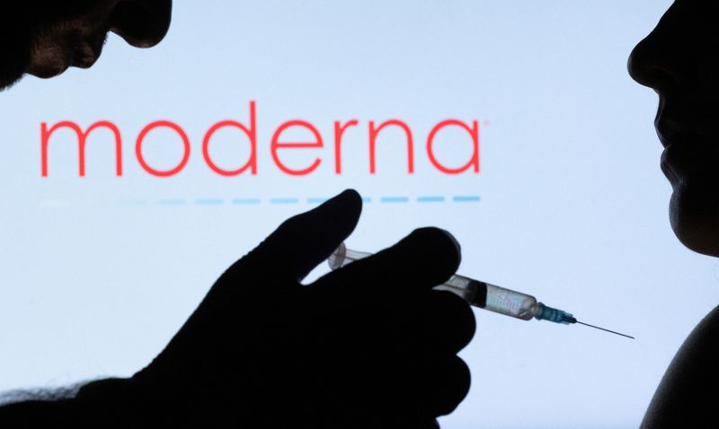 &copy; Reuters. People pose with syringe with needle in front of displayed Moderna logo in this illustration taken, December 11, 2021. REUTERS/Dado Ruvic/Illustration/Files