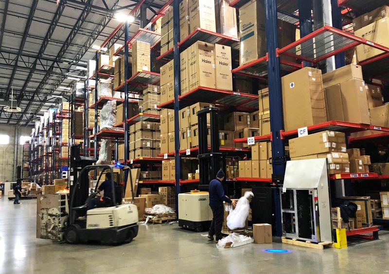 &copy; Reuters. FILE PHOTO: Warehouse workers deal with inventory stacked up to the ceiling at an ABT Electronics Facility in Glenview, Illinois, U.S. December 4, 2018. Picture taken December 4, 2018. REUTERS/Richa Naidu/File Photo