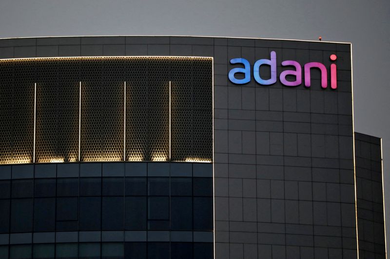 © Reuters. FILE PHOTO: The logo of the Adani Group is seen on the facade of one of its buildings on the outskirts of Ahmedabad, India, April 13, 2021. REUTERS/Amit Dave/File Photo
