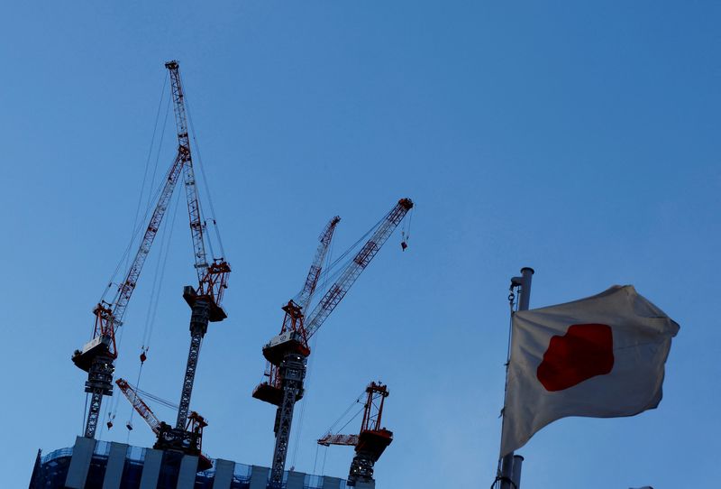 &copy; Reuters. FILE PHOTO: Japan's national flag flutters in front of a construction site of a commercial building in Tokyo, Japan, February 17, 2022. REUTERS/Kim Kyung-Hoon/File Photo