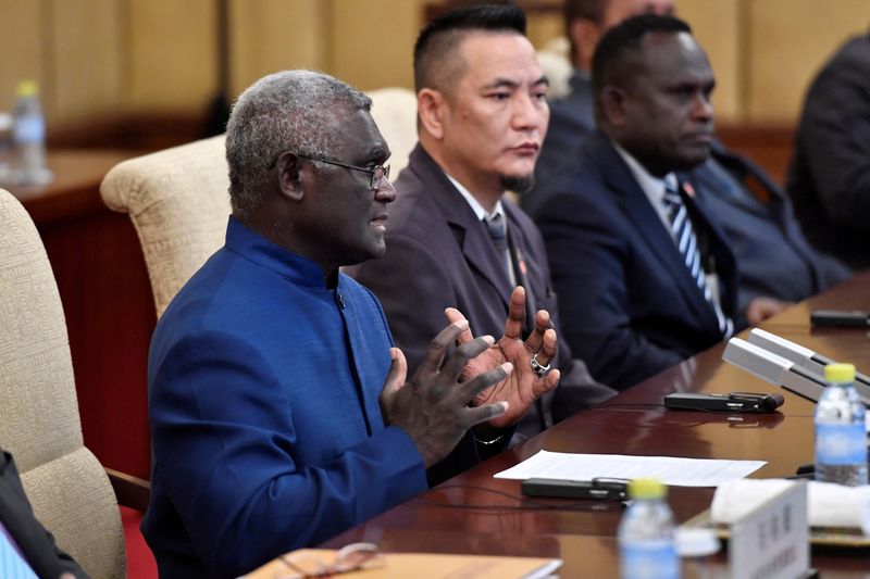 &copy; Reuters. FILE PHOTO: Solomon Islands Prime Minister Manasseh Sogavare talks to Chinese President Xi Jinping (not pictured) during their meeting at the Diaoyutai State Guesthouse in Beijing, China, October 9, 2019. Parker Song/Pool via REUTERS/File Photo