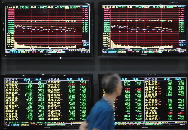 &copy; Reuters. A man walks past screens showing stock information at a brokerage house in Jiujiang, Jiangxi province, China October 8, 2018. REUTERS/Stringer 