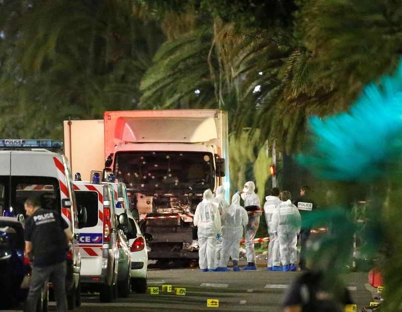 &copy; Reuters. FILE PHOTO: French police forces and forensic officers stand next to a truck July 15, 2016 that ran into a crowd celebrating the Bastille Day national holiday on the Promenade des Anglais killing at least 60 people in Nice, France, July 14, 2016.    REUTE
