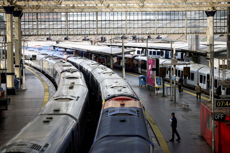 &copy; Reuters. FILE PHOTO: A view of trains on the platform at Waterloo Station as a station worker stands nearby, on the first day of national rail strike in London, Britain, June 21, 2022. REUTERS/Henry Nicholls