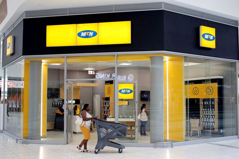 &copy; Reuters. FILE PHOTO: A shopper walks past an MTN shop at a mall in Johannesburg, South Africa, March 2, 2017. REUTERS/Siphiwe Sibeko/File Photo