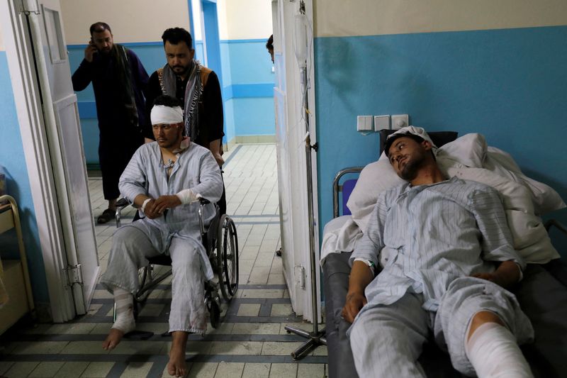 © Reuters. Men who were wounded after a suicide bomber detonated explosives near the entrance of the Russian embassy, are treated inside a hospital in Kabul, Afghanistan, September 5, 2022. REUTERS/Ali Khara