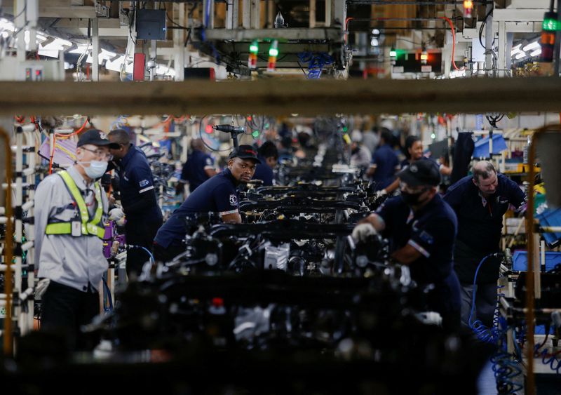 &copy; Reuters. FILE PHOTO: Workers assemble vehicles as operations begin after flooding in April shut down the Toyota South Africa Motors plant in Durban, South Africa, August 16, 2022. REUTERS/Rogan Ward