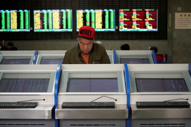 &copy; Reuters. An investor looks at computer screens showing stock information at a brokerage house in Shanghai, China May 6, 2019. REUTERS/Aly Song