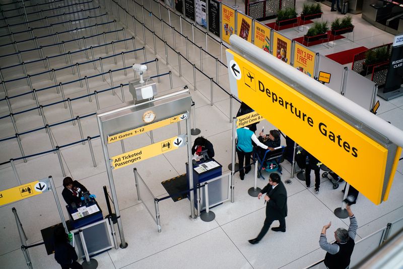 © Reuters. FILE PHOTO: People walk to reach immigration process at the John F. Kennedy International Airport in New York, U.S., March 9, 2020. REUTERS/Eduardo Munoz/File Photo