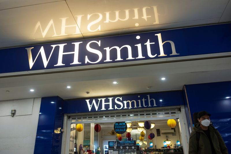 &copy; Reuters. A person wearing a mask is pictured outside a branch of WH Smith in London, Britain, December 1, 2021. Picture taken December 1, 2021. REUTERS/May James