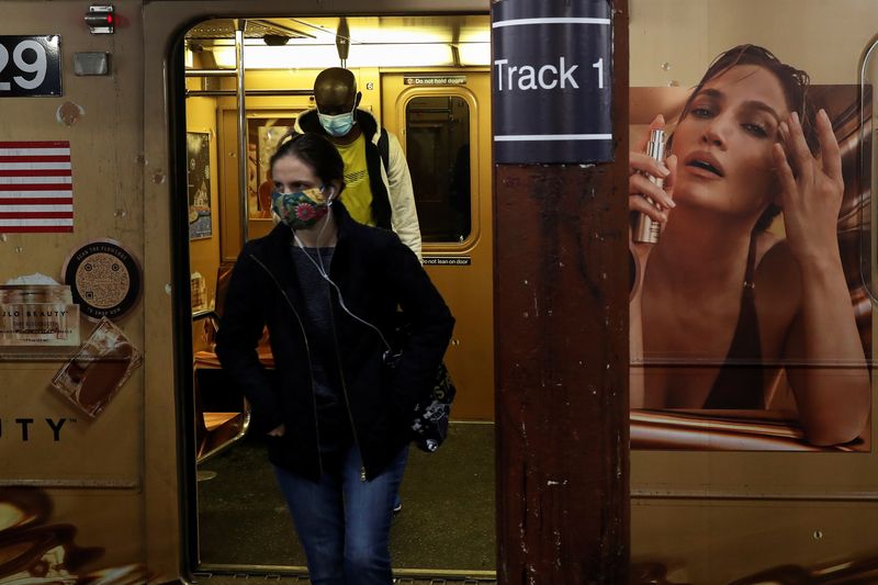 &copy; Reuters. FILE PHOTO: Subway riders wearing protective face masks exit the shuttle train during the coronavirus pandemic at the Times Square stop in New York City, U.S., March 11, 2021. REUTERS/Shannon Stapleton
