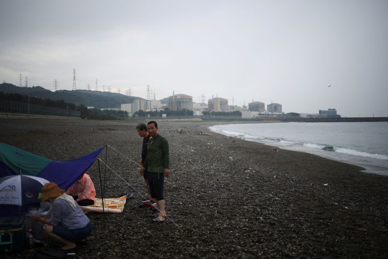 &copy; Reuters. People camp at a seashore as Wolseong Nuclear Power Plant is seen in the background in Gyeongju, South Korea, August 20, 2022. REUTERS/Kim Hong-Ji
