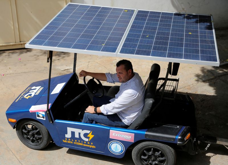 &copy; Reuters. FILE PHOTO: Jose Cintron, a 43-year-old electrical technician, sits in a solar-powered car he developed, in Maracaibo, Venezuela August 30, 2022. REUTERS/Jose Angel Nunez