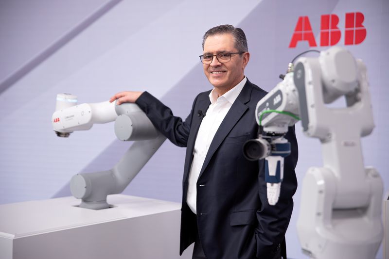 &copy; Reuters. FILE PHOTO: Head of ABB Robotics and Discrete Automation business Sami Atiya poses next to robots in Zurich, Switzerland February 22, 2021. ABB/Oliver Baer/Handout via REUTERS /File Photo
