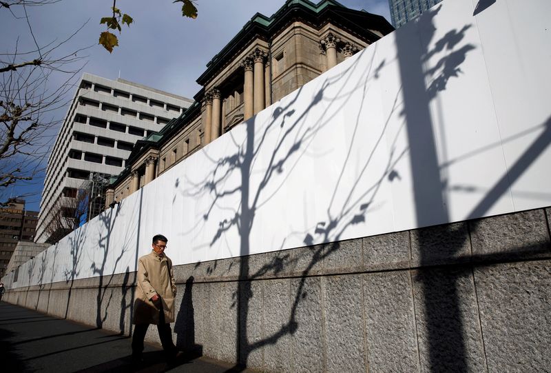 &copy; Reuters. FILE PHOTO: A man walks past the Bank of Japan building in Tokyo, Japan January 15, 2018. REUTERS/Kim Kyung-Hoon/File Photo