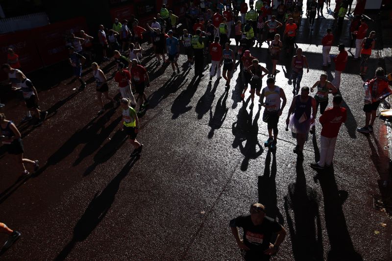 &copy; Reuters. FILE PHOTO: Athletics - London Marathon - London, Britain - October 3, 2021 Runners reacts at the end of the race Action Images via Reuters/Andrew Boyers