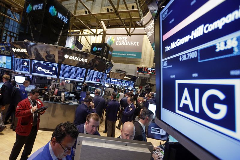 © Reuters. The American International Group, Inc. (AIG) stock ticker is seen on a monitor as traders work on the floor of the New York Stock Exchange after the opening bell February 11, 2013.  REUTERS/Brendan McDermid  
