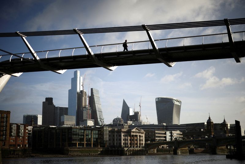 &copy; Reuters. FILE PHOTO: The City of London financial district is seen as a person walks over Millennium Bridge in London, Britain, February 16, 2022. REUTERS/Henry Nicholls
