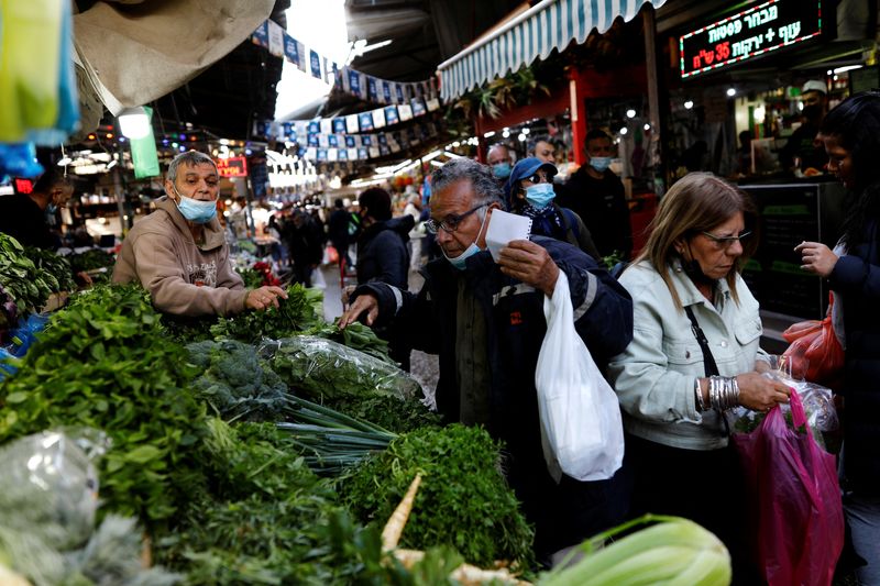 &copy; Reuters. FILE PHOTO: Israelis shop at a food market ahead of the upcoming Jewish holiday of Passover as the country begins to emerge from coronavirus disease (COVID-19) pandemic closures due to its rapid vaccine roll-out, in Tel Aviv, Israel, March 26, 2021. REUTE