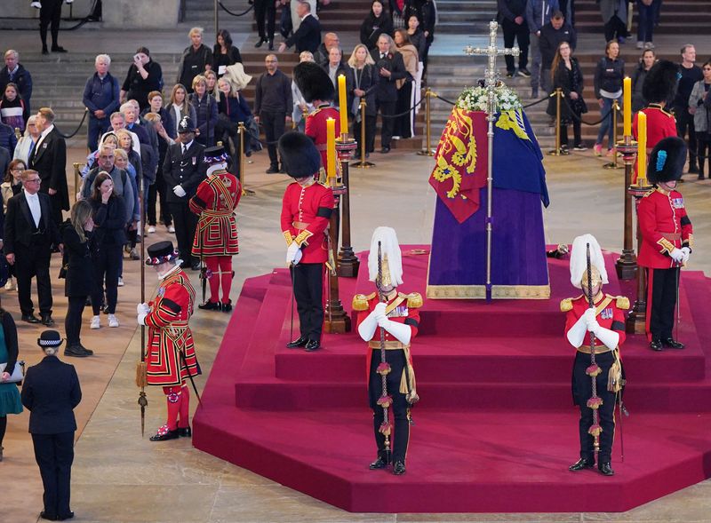 &copy; Reuters. Members of the public file past the coffin of Queen Elizabeth II, draped in the Royal Standard with the Imperial State Crown and the Sovereign's orb and sceptre, lying in state on the catafalque in Westminster Hall, at the Palace of Westminster, London, S