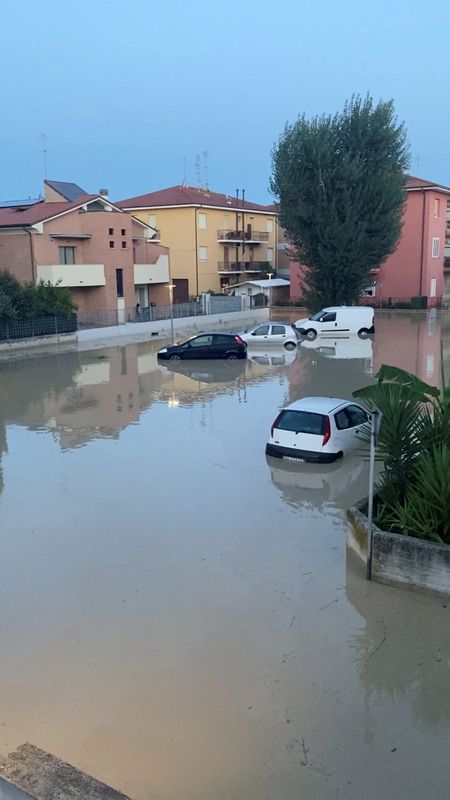 &copy; Reuters. المياه تغمر سيارات في وسط إيطاليا في صورة من وسائل التواصل الاجتماعي يوم الجمعة. محظور إعادة بيع الصورة أو وضعها في أرشيف.