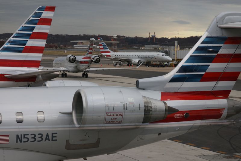 © Reuters. A jet from American Eagle, a regional branch of American Airlines (AA), taxis past other AA aircraft at Ronald Reagan Washington National Airport in Arlington, Virginia, U.S. December 3, 2021.  REUTERS/Chris Helgren