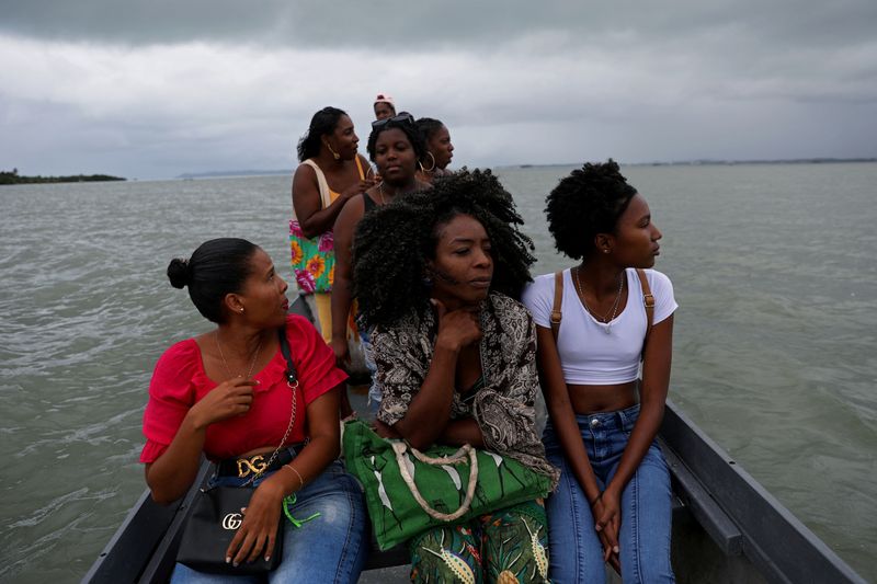 © Reuters. Eliete Paraguassu, 42, who is the first candidate from Ilha de Mare to run for state deputy in Bahia, travels by boat with her friends and family from Ilha de Mare to the mainland, in Salvador, Bahia State, Brazil August 21, 2022. Paraguassu is one of the record number of Black candidates running for state and federal office in October 2022 elections.  REUTERS/Amanda Perobelli         