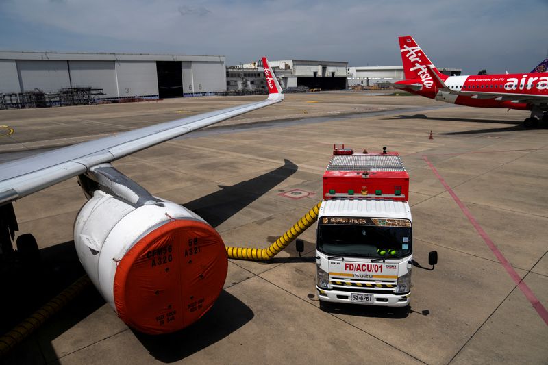 &copy; Reuters. FILE PHOTO: A Thai AirAsia aircraft engine is seen covered, after not being used during the coronavirus disease (COVID-19) pandemic, on the tarmac of Bangkok's Don Muang International Airport, Thailand, October 27, 2021. Picture taken October 27, 2021. RE