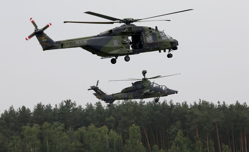 &copy; Reuters. FILE PHOTO: A German Bundeswehr armed forces NH 90 helicopter (top) and a Tiger attack helicopter are seen during a drill for the upcoming ILA Berlin Air Show at Holzdorf Air Base, south of Berlin, Germany, May 25, 2016.    REUTERS/Fabrizio Bensch/File Ph