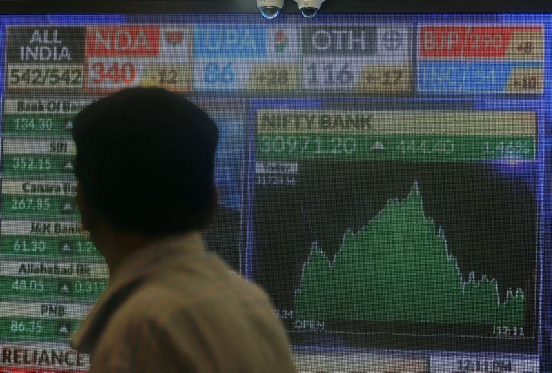 &copy; Reuters. A man looks at a screen displaying news of markets update inside the Bombay Stock Exchange (BSE) building in Mumbai, India, May 23, 2019. REUTERS/Francis Mascarenhas