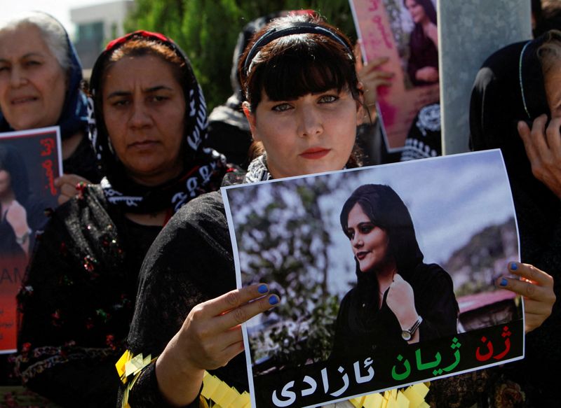 &copy; Reuters. امرأة تحمل صورة الإيرانية مهسا أميني التي توفيت خلال احتجازها لدى الشرطة الإيرانية في مظاهرات خارج مكتب الأمم المتحدة في مدينة أربيل يوم ال