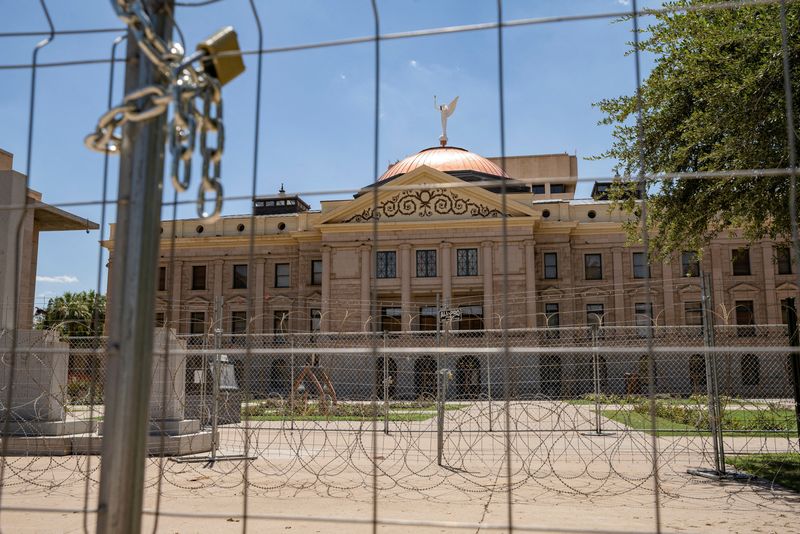 &copy; Reuters. FILE PHOTO: Fencing including razor wire forms a barrier to the Arizona state Capitol complex after it was installed following protests against the United States Supreme Court after it overturned the landmark Roe v Wade abortion decision, in Phoenix, Ariz