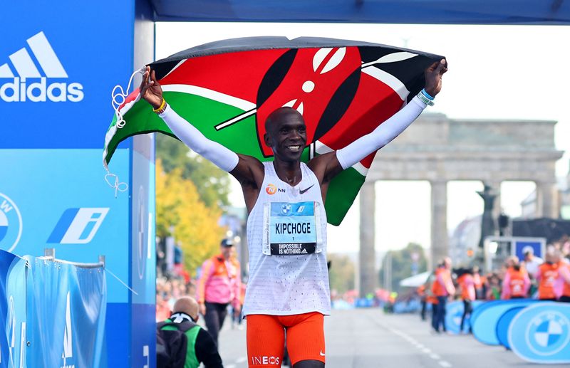Athletics-Kenya Kipchoge breaks marathon world record in Berlin