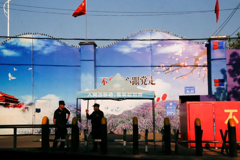 &copy; Reuters. FILE PHOTO: Security guards stand at the gates of what is officially known as a vocational skills education center in Huocheng County in Xinjiang Uighur Autonomous Region, China September 3, 2018.REUTERS/Thomas Peter/File Photo