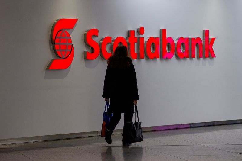 &copy; Reuters. A person walks infant of a sign for The Bank of Nova Scotia, operating as Scotiabank, in Toronto, Ontario, Canada December 13, 2021.  REUTERS/Carlos Osorio