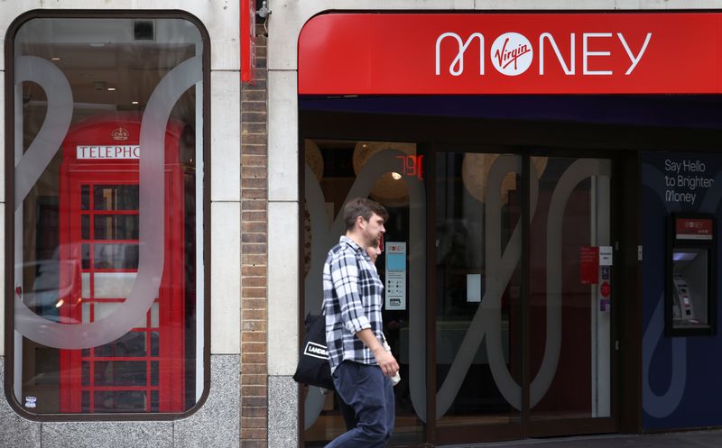 &copy; Reuters. FILE PHOTO: People walk past a Virgin Money store in central London, Britain, July 27, 2021. REUTERS/Henry Nicholls/File Photo