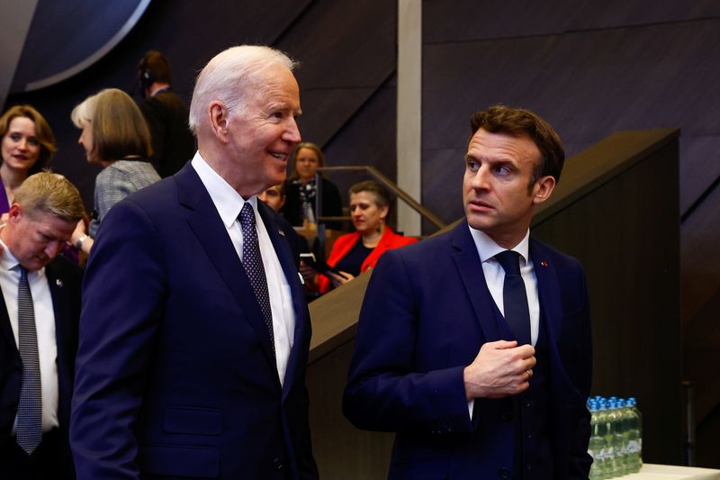 &copy; Reuters. FOTO DE ARCHIVO: El presidente de Estados Unidos, Joe Biden, habla con su par francés, Emmanuel Macron, antes de una cumbre de la OTAN para discutir la invasión de Rusia a Ucrania, en la sede de la alianza en Bruselas, Bélgica, el 24 de marzo de 2022. 