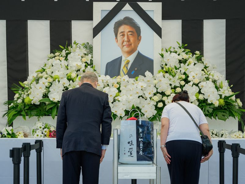 With flowers and a gun salute, Japan bids farewell to divisive Abe