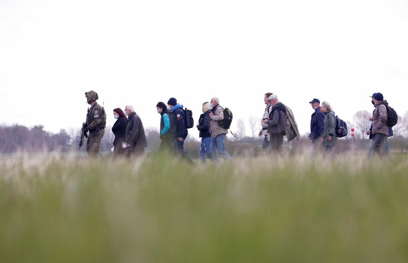 &copy; Reuters. FILE PHOTO: A soldier leads people during the "Schneller Adler" or "Fast Eagle" exercise of evacuation of refugees at an airport in Barth, North Germany May 5, 2022. REUTERS/Michele Tantussi