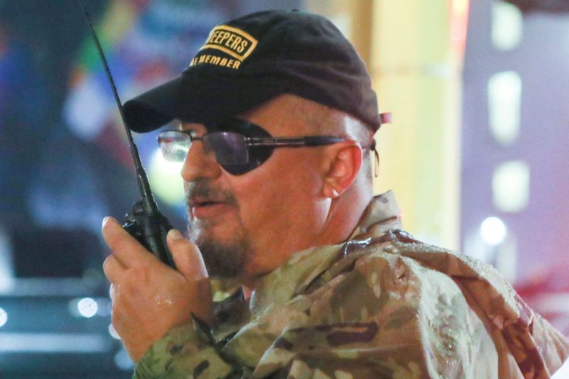 © Reuters. FILE PHOTO: Oath Keepers militia founder Stewart Rhodes uses a radio as he departs with volunteers from a rally held by U.S. President Donald Trump in Minneapolis, Minnesota, U.S. October 10, 2019. REUTERS/Jim Urquhart/File Photo