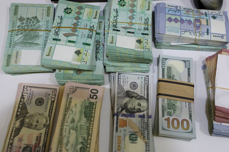 &copy; Reuters. FILE PHOTO: U.S. dollar banknotes and Lebanese pounds are pictured at a currency exchange shop in Beirut, Lebanon March 2, 2021. REUTERS/Mohamed Azakir/File Photo