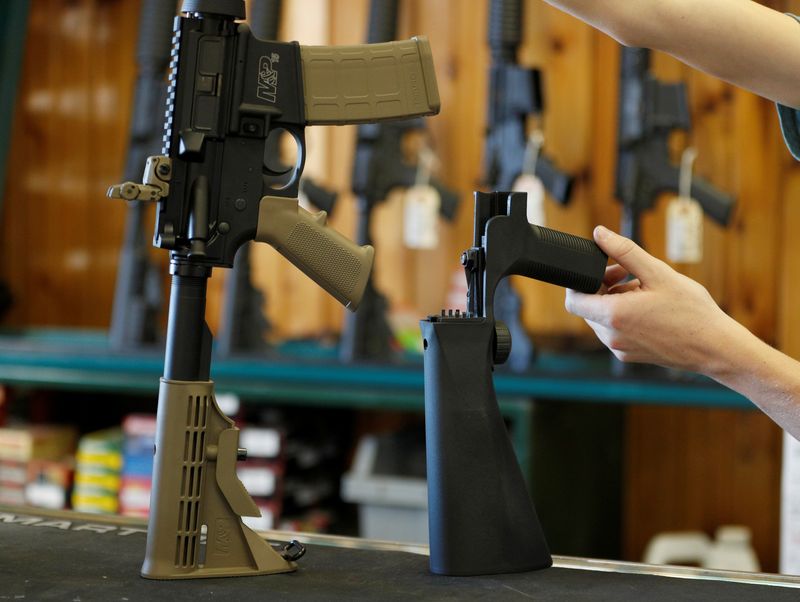 &copy; Reuters. FILE PHOTO: A bump fire stock, (R), that attaches to a semi-automatic rifle to increase the firing rate is seen at Good Guys Gun Shop in Orem, Utah, U.S., October 4, 2017. REUTERS/George Frey