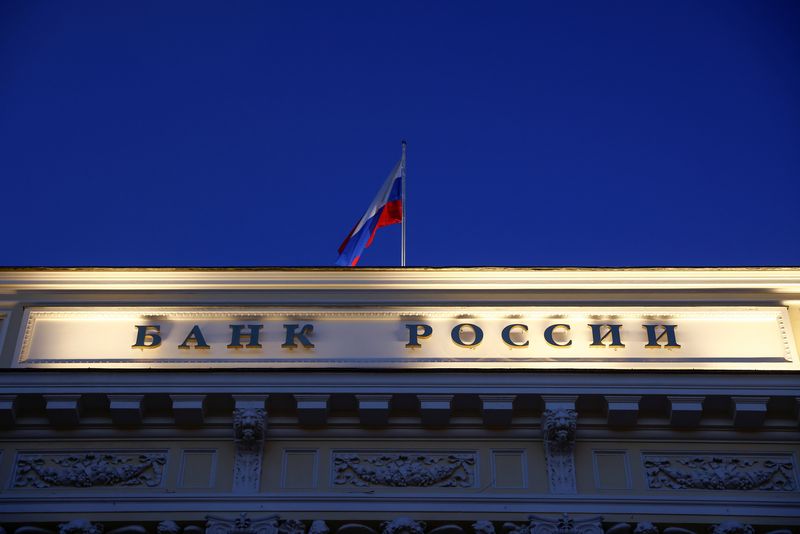 &copy; Reuters. FILE PHOTO: A Russian state flag flies over the Central Bank headquarters in Moscow, Russia March 29, 2021. A sign reads: "Bank of Russia". REUTERS/Maxim Shemetov/File Photo