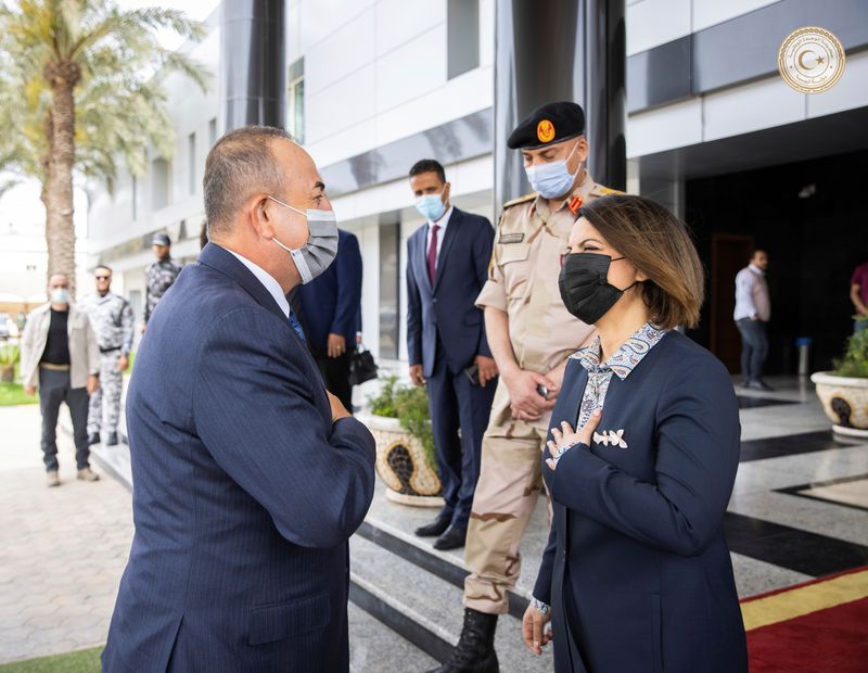 &copy; Reuters. Turkish Foreign Minister Mevlut Cavusoglu is welcomed by Libyan Foreign Minister Najla el-Mangoush in Tripoli, Libya, May 3, 2021. Media Office of the Prime Minister/Handout via REUTERS